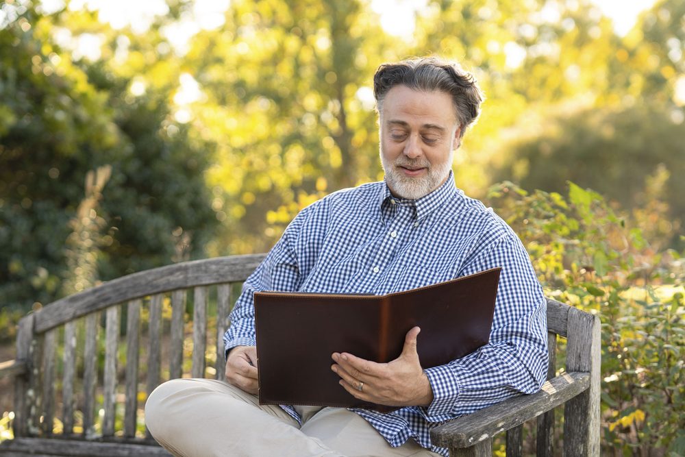 man looking at album